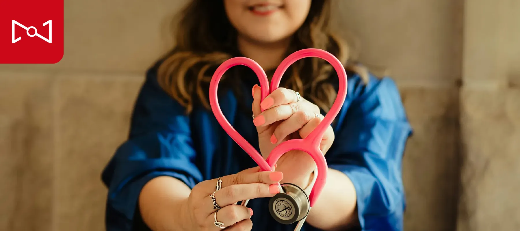 doctor holding a heart shaped stethoscope