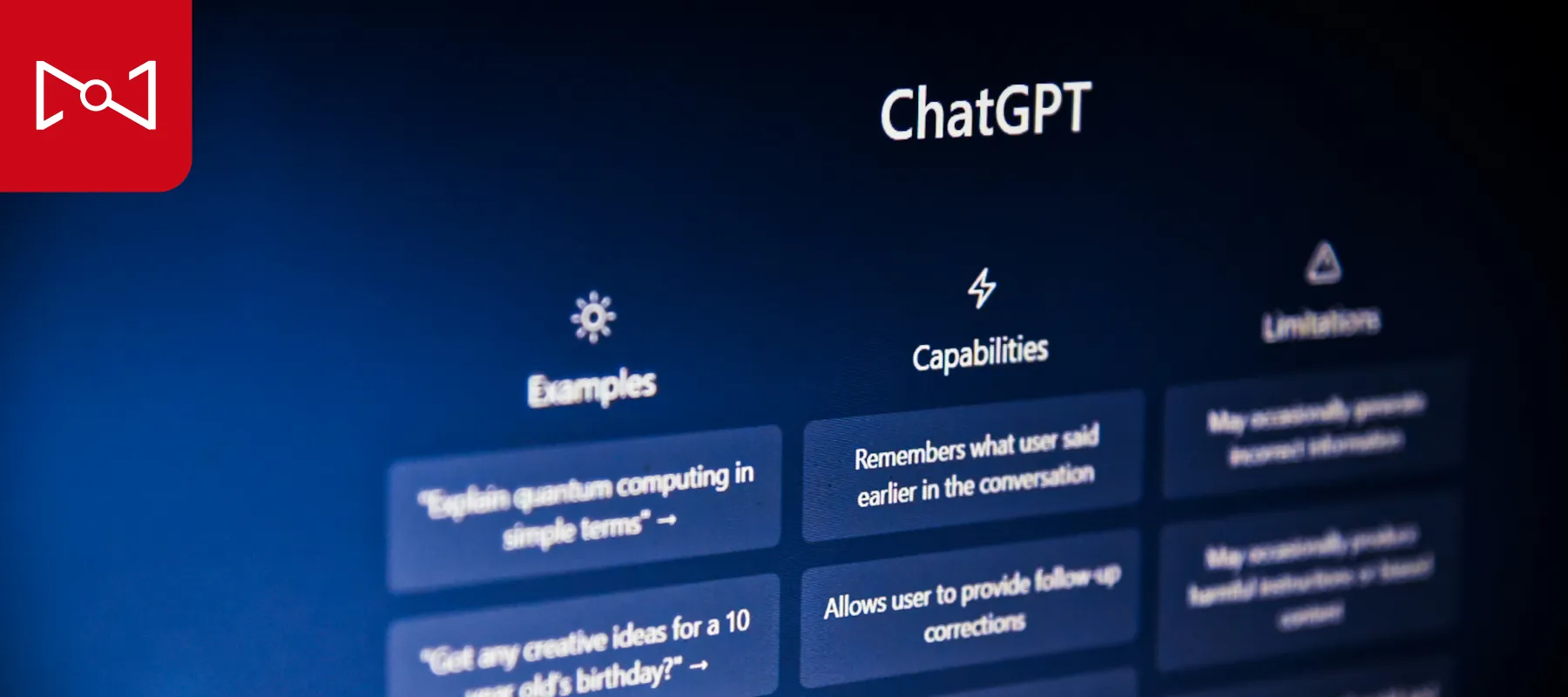 A close-up angled shot of a computer monitor displaying the classic ChatGPT user interface against a dark blue background.